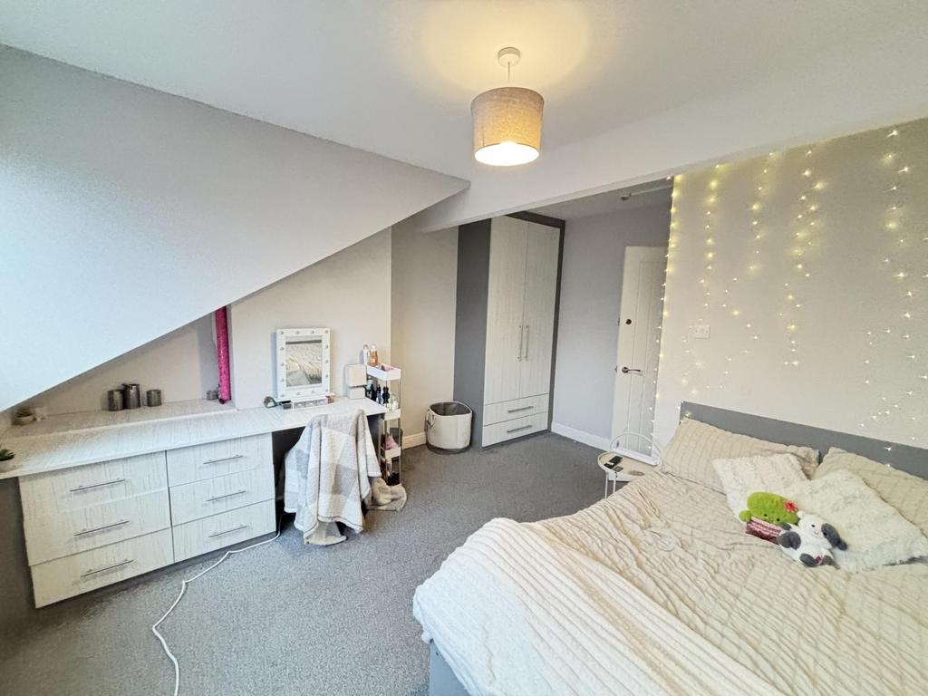 A well-maintained bedroom featuring a comfortab...