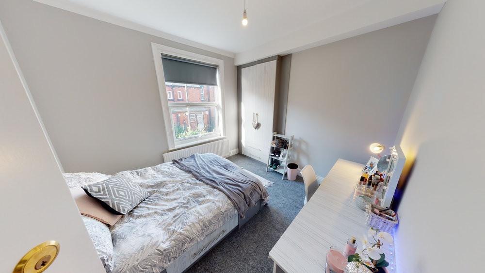 A well-lit, comfortable double bedroom featurin...