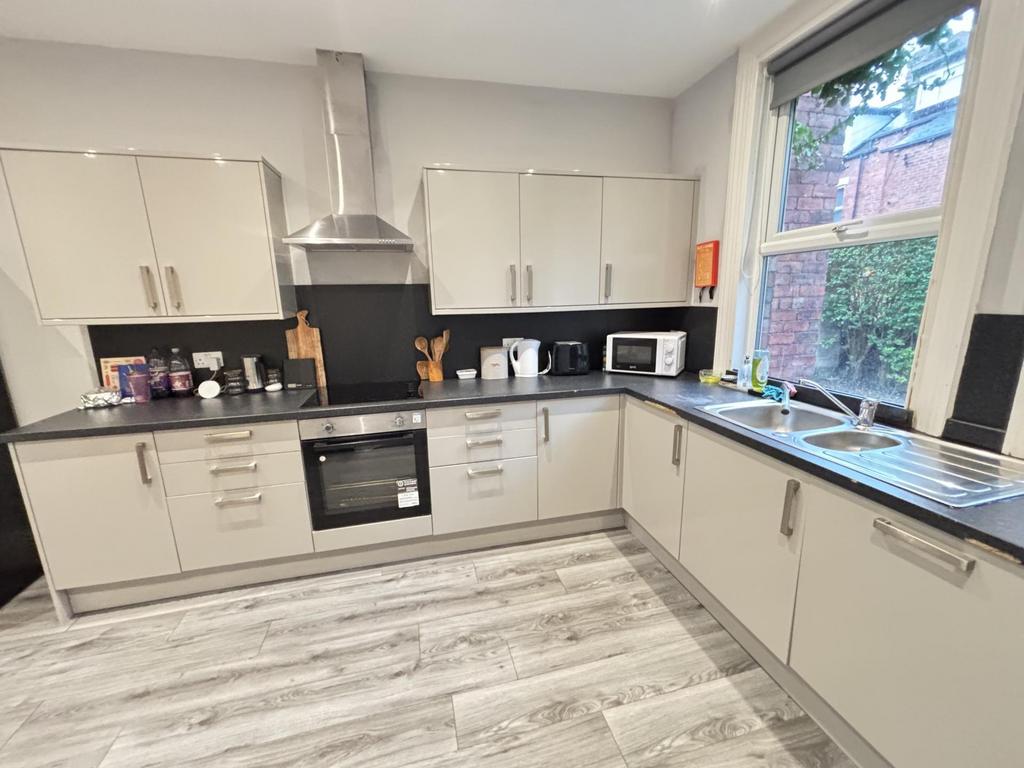 Bright modern kitchen with light cabinetry, int...