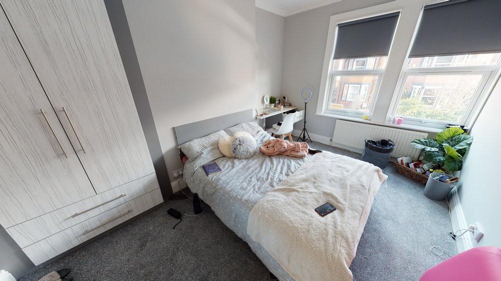 Bright and well-maintained bedroom with a cozy ...