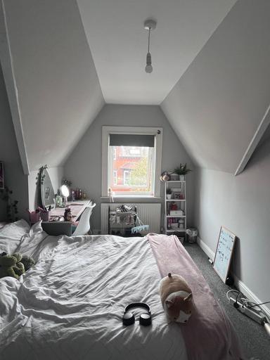 Bright and welcoming master bedroom with a larg...