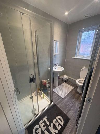 A modern bathroom featuring a walk-in shower, t...