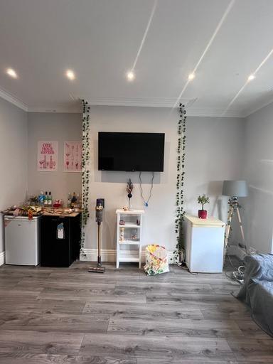 A modern, well-lit living room featuring a larg...