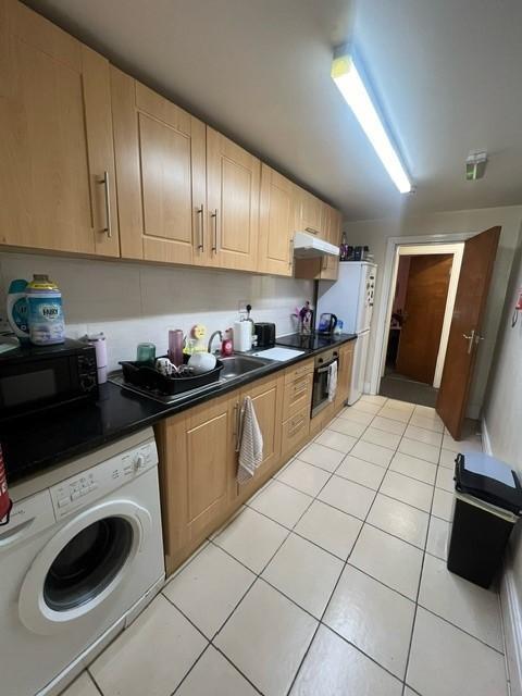 A well-equipped kitchen featuring wooden cabine...