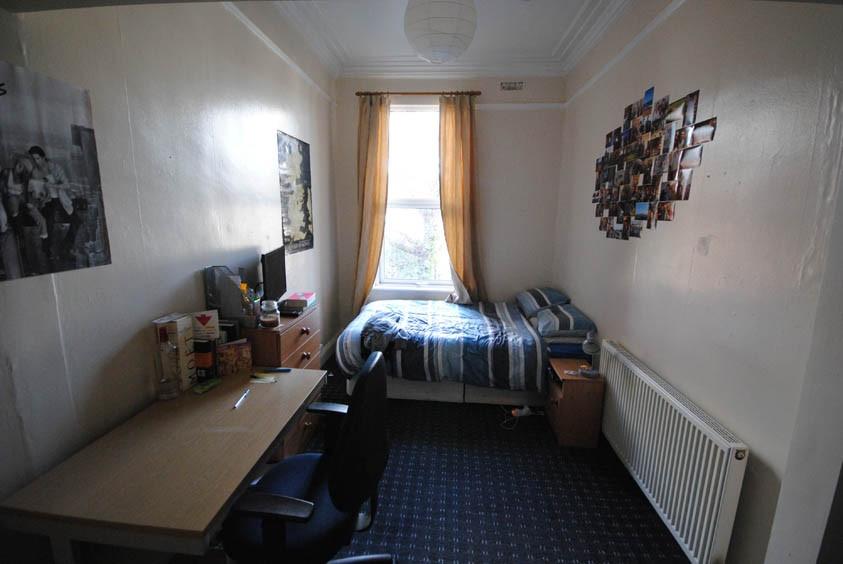 A cozy and well-maintained bedroom featuring a ...