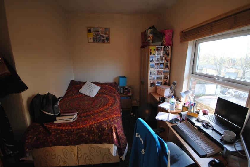 A cozy bedroom featuring a double bed with a co...