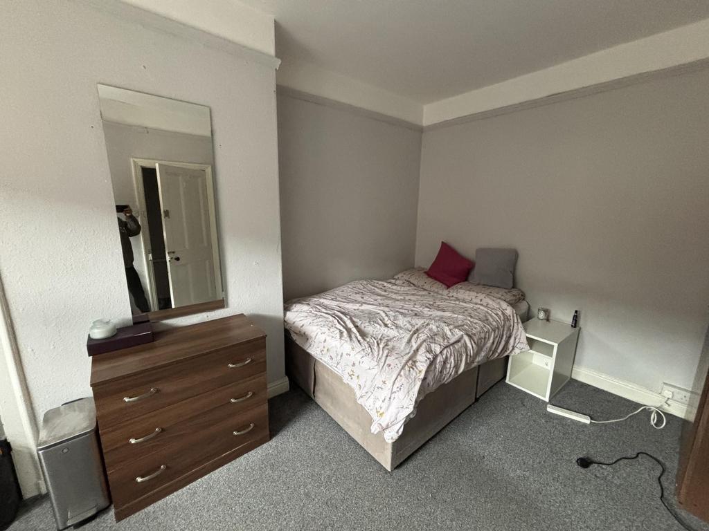 A comfortable double bedroom featuring a spacio...