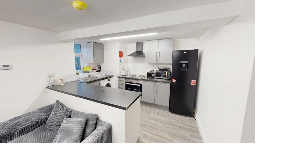 A well-lit, modern kitchen with a clean and min...