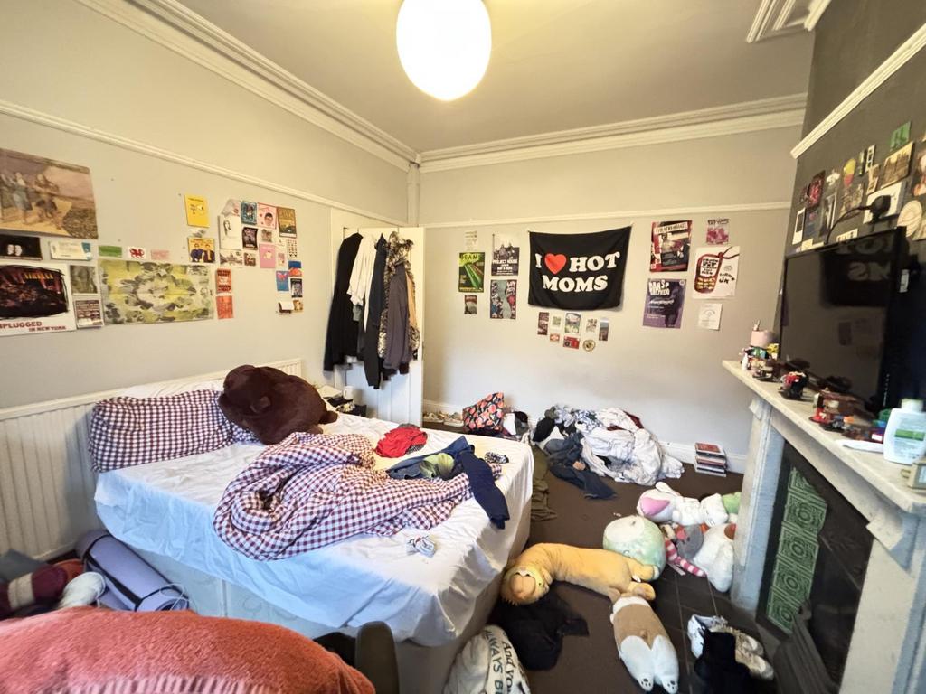 A spacious master bedroom filled with soft natu...