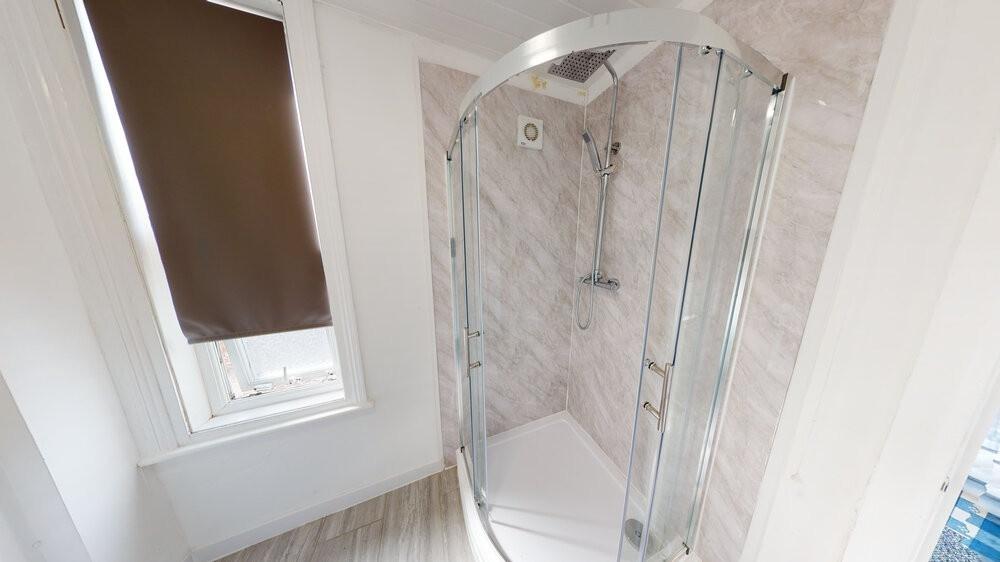 A spacious and modern bathroom featuring a larg...