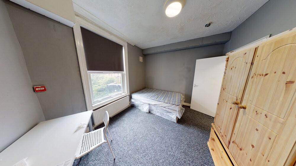 A small and simple room with limited natural li...