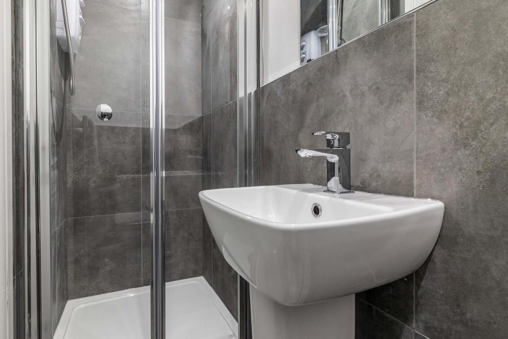 A clean and modern bathroom featuring a white s...