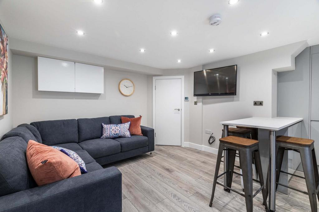 A spacious and modern living room featuring a l...