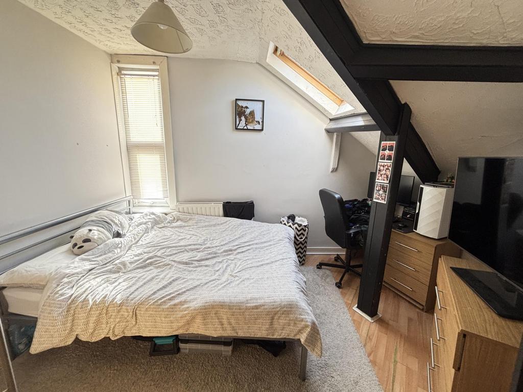 Cozy and bright bedroom featuring a comfortable...