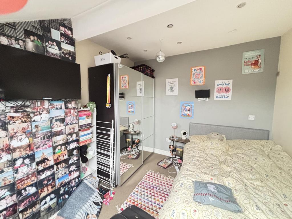 A cozy student bedroom featuring a comfortable ...