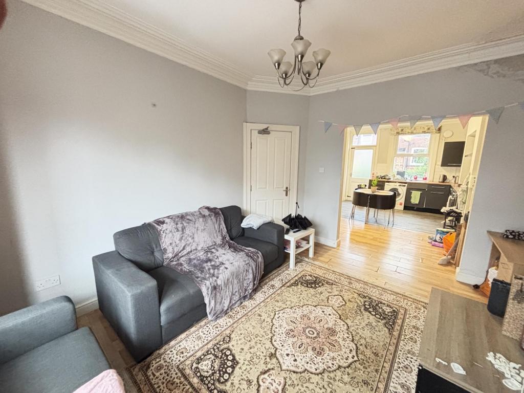 A spacious and welcoming living room with a lar...