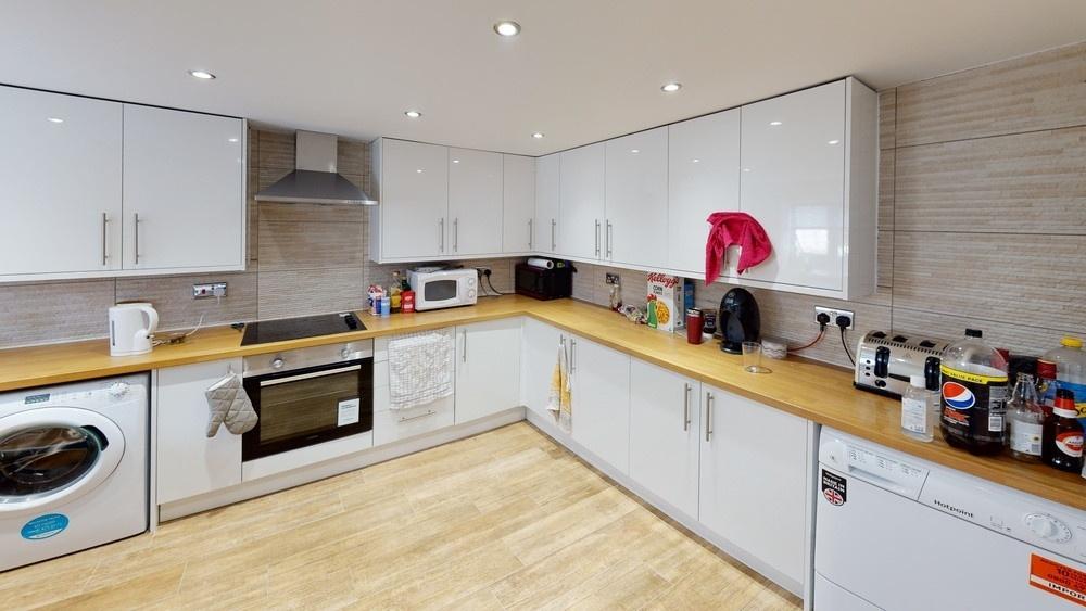 Bright and modern kitchen with ample cabinetry ...