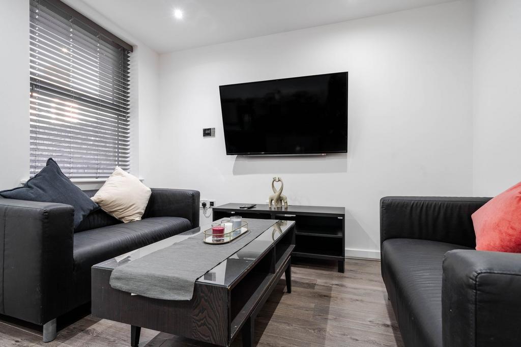 Modern living room featuring two black leather ...