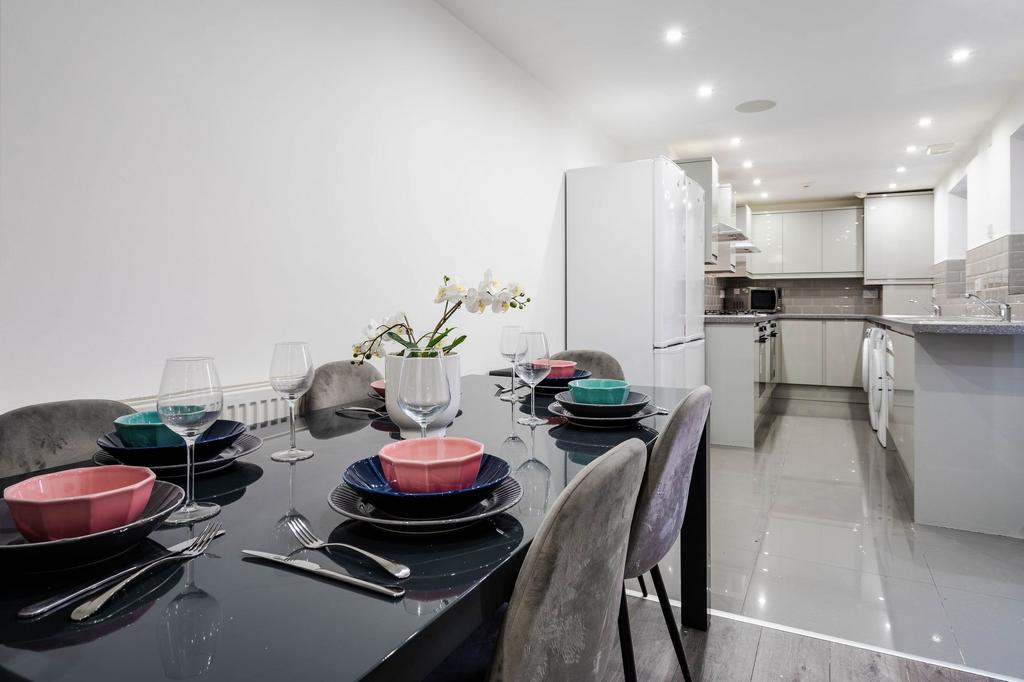 Modern and bright kitchen with sleek white cabi...