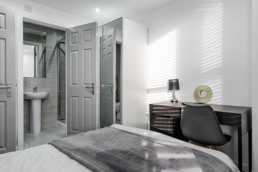 A bright, clean bathroom featuring a pedestal s...