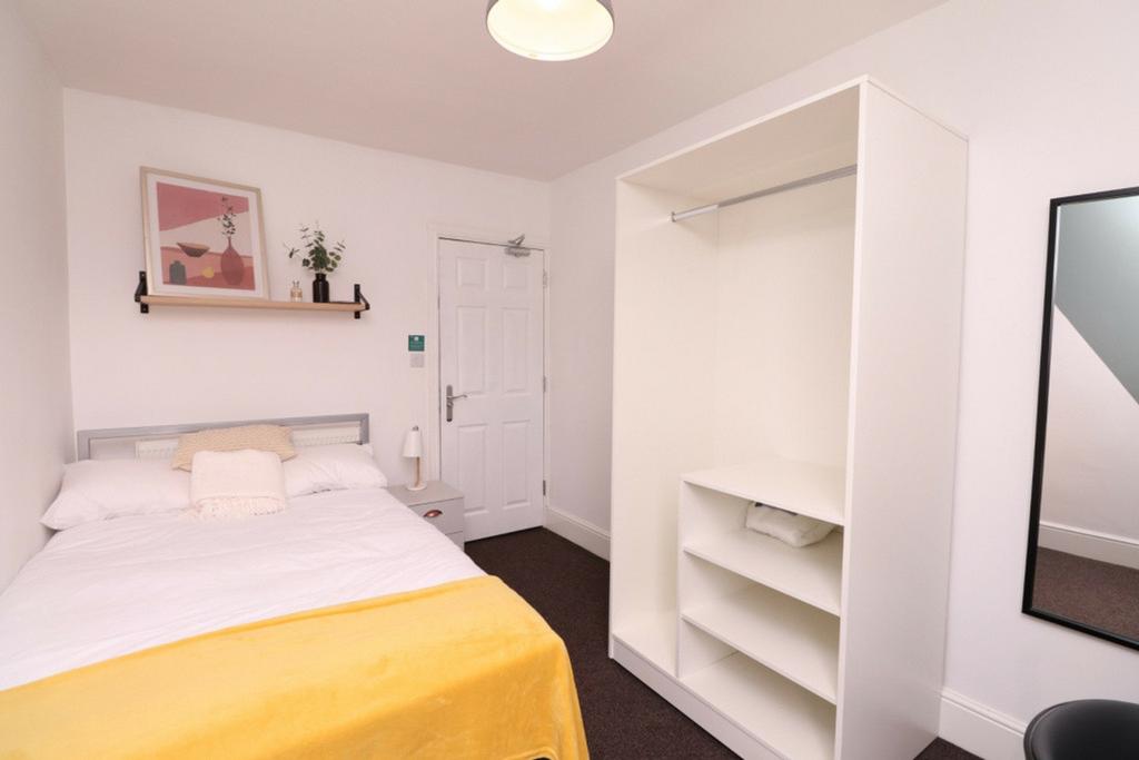 A bright and inviting double bedroom featuring ...