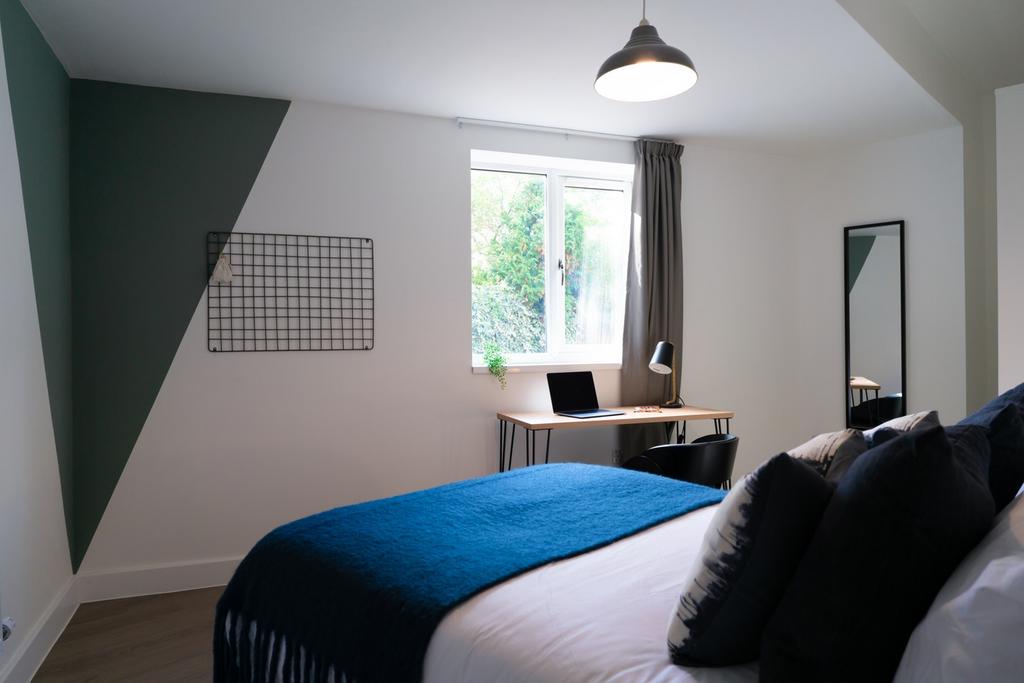 A bright and inviting double bedroom featuring ...