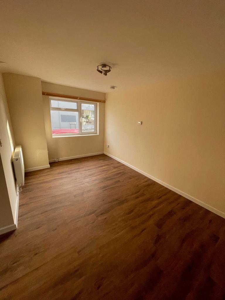 A bright, spacious living room with a large win...