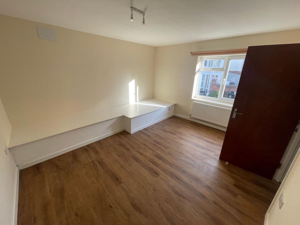 Bright and welcoming bedroom with a large windo...