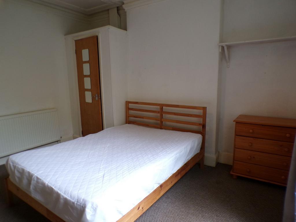 Simple, neutrally decorated double bedroom with...