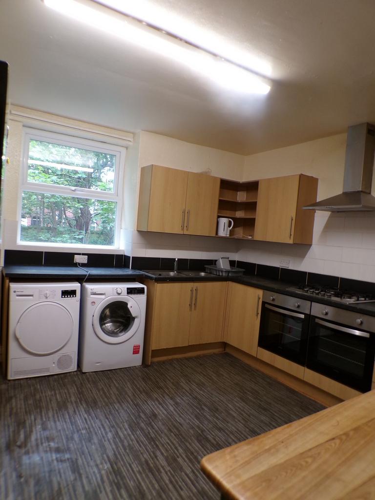 Bright fitted kitchen with modern wood-effect c...