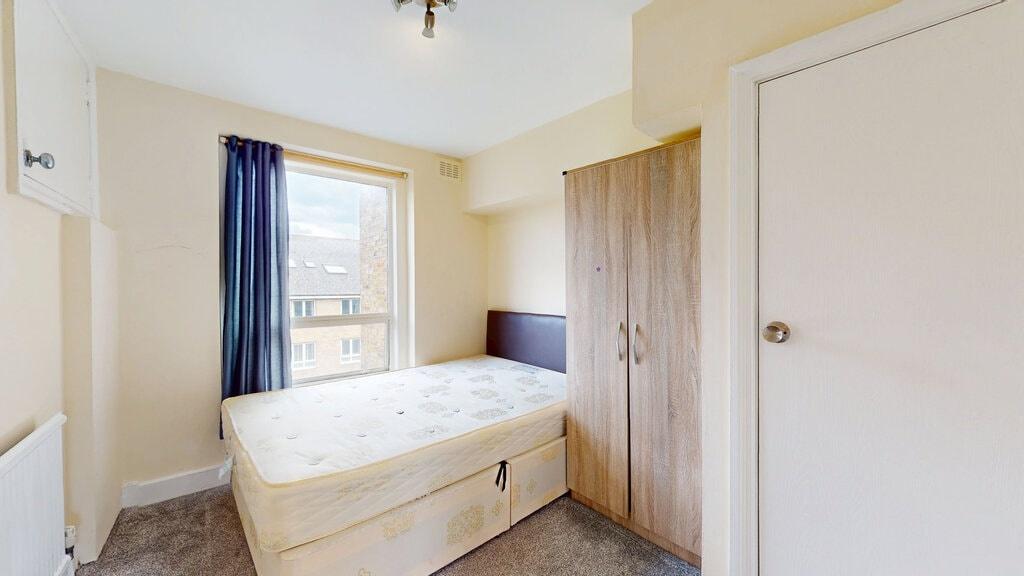 A cozy single bedroom featuring a comfortable s...