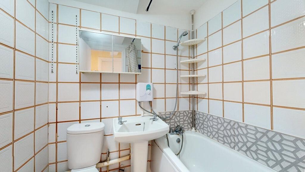 A clean and functional bathroom suite featuring...