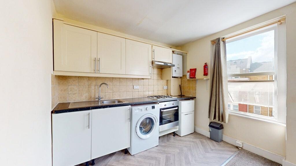 Bright kitchen with a large window letting in n...