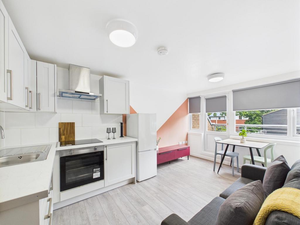 Bright open-plan living area with a modern fitt...