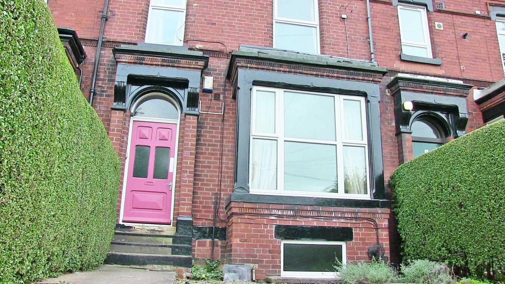 Brick-fronted terraced house with a bright pink...