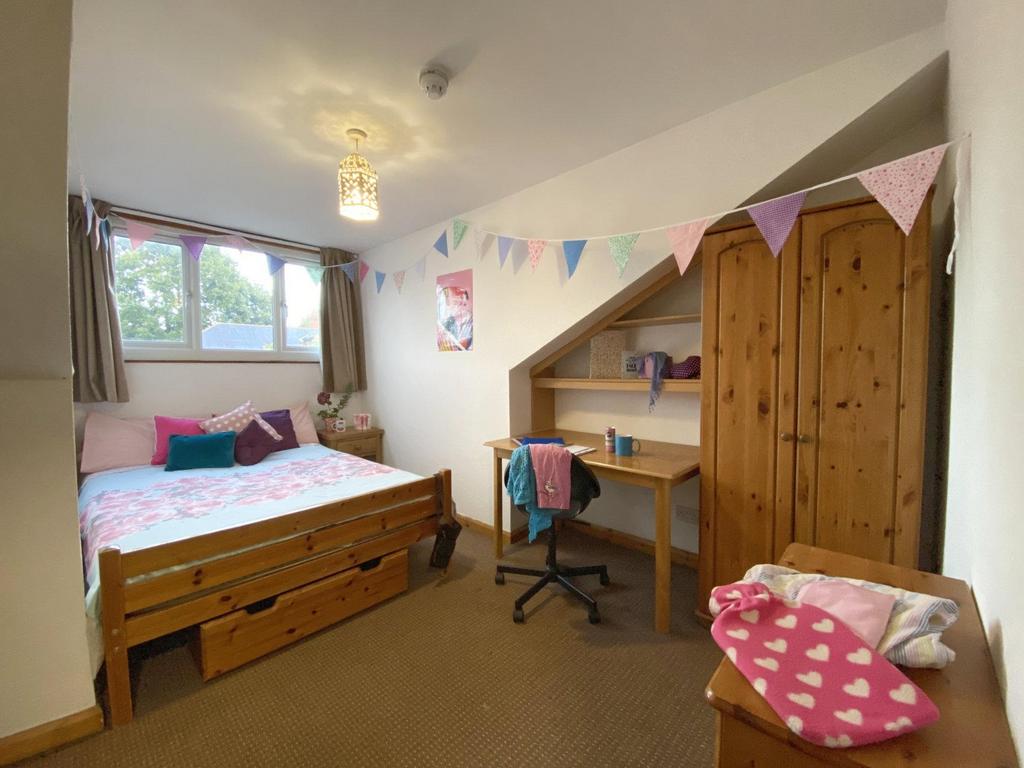 Bright, cosy bedroom with a wooden double bed, ...