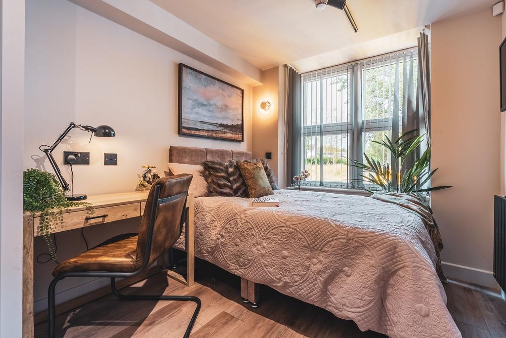 Bright, stylish bedroom with a comfortable doub...