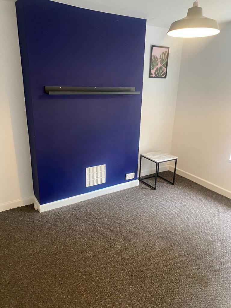 A modern living room featuring a bold blue acce...