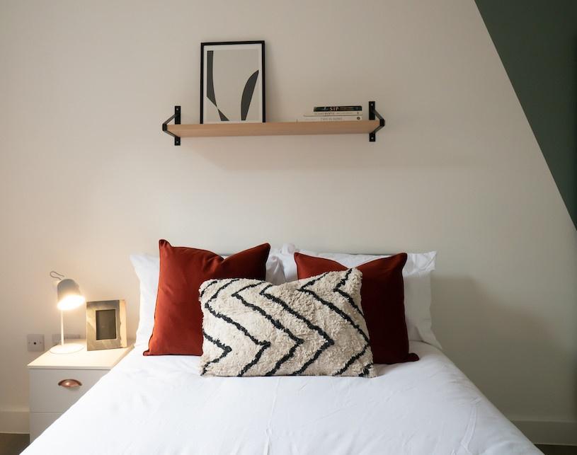 A stylish and spacious master bedroom featuring...