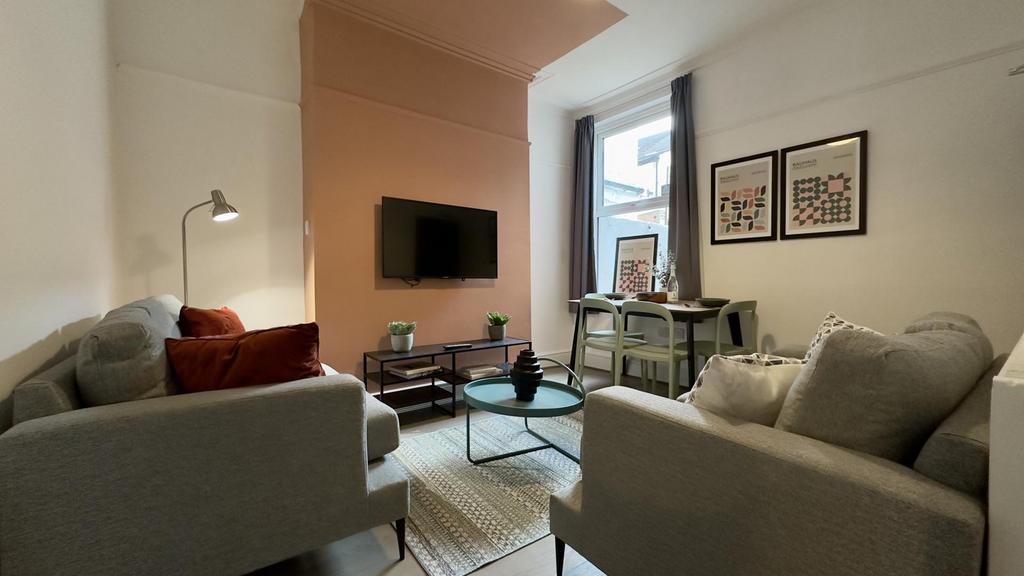 A spacious and stylish living room with modern ...