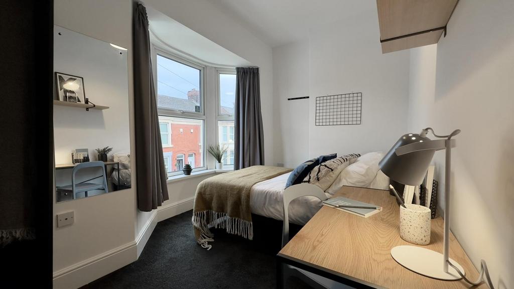 A bright and inviting double bedroom featuring ...