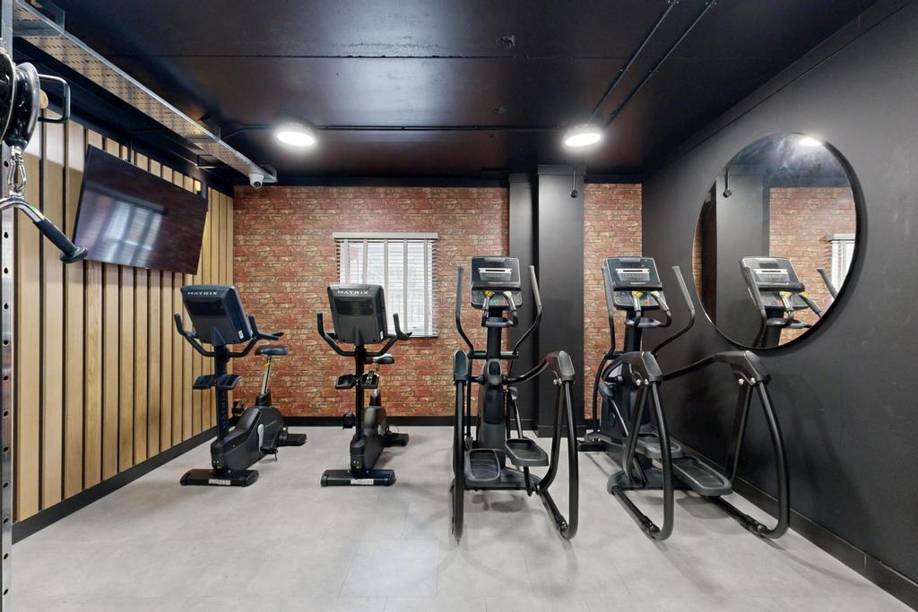 Modern private gym room with several cardio mac...