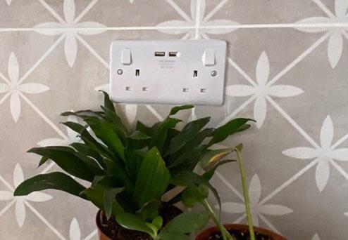 Close-up of a stylish wall socket set against p...