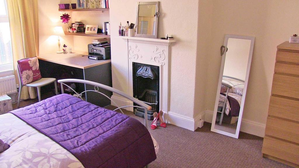 Bright, warmly decorated double bedroom with a ...