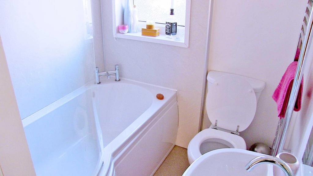 Bright, well-kept bathroom with a modern white ...