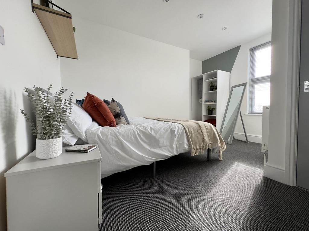 A spacious and inviting double bedroom featurin...