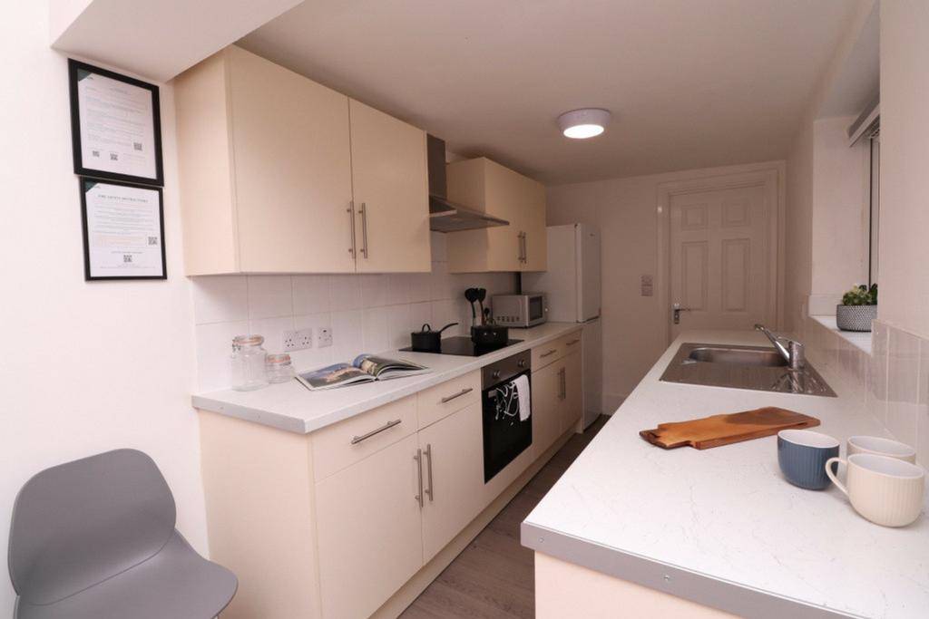 A modern and tidy kitchenette featuring sleek c...