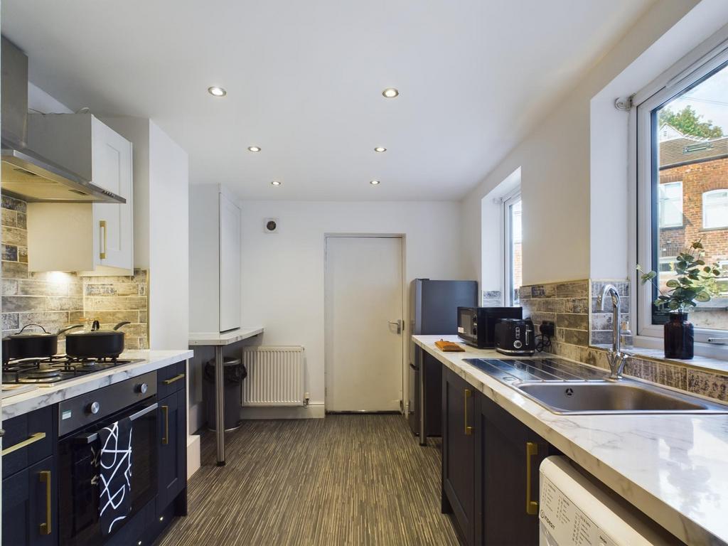 A bright and modern kitchen with ample space fo...