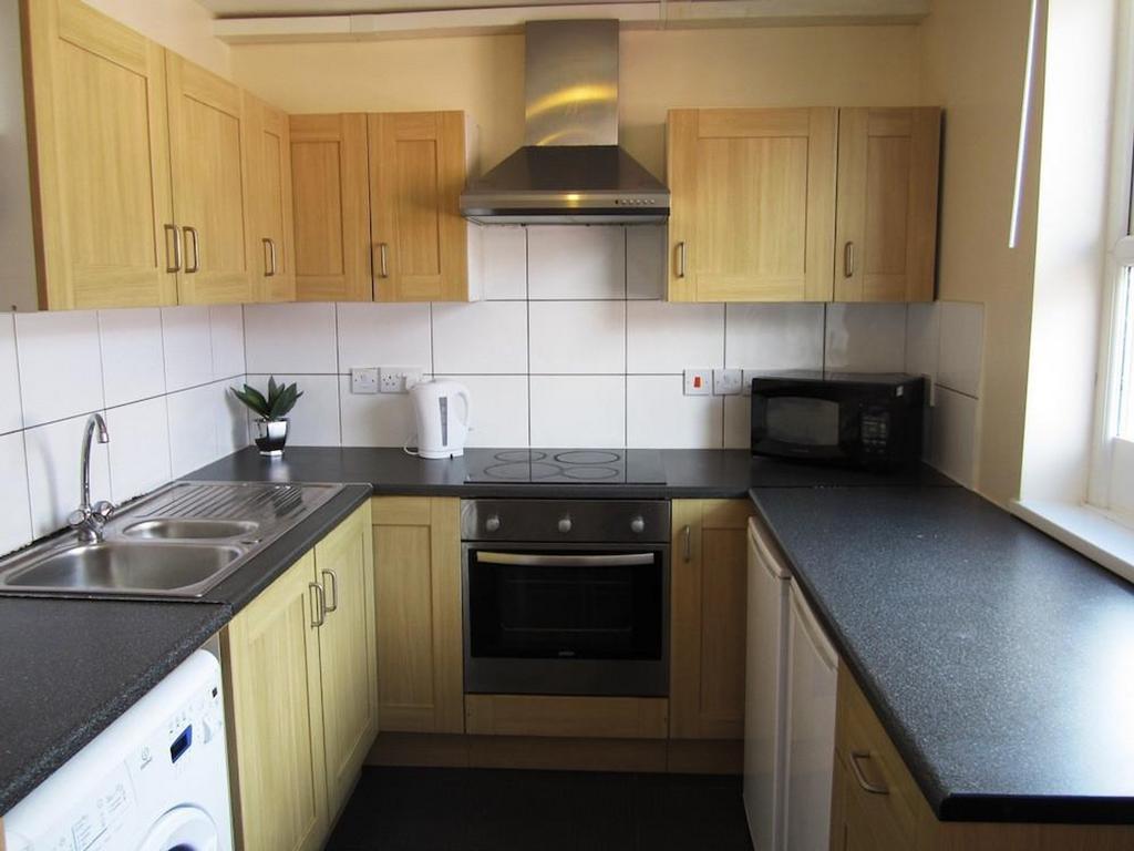 A bright and tidy kitchenette with modern appli...