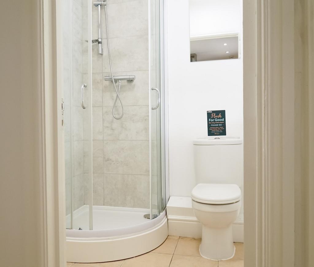 A clean and modern bathroom with a shower enclo...
